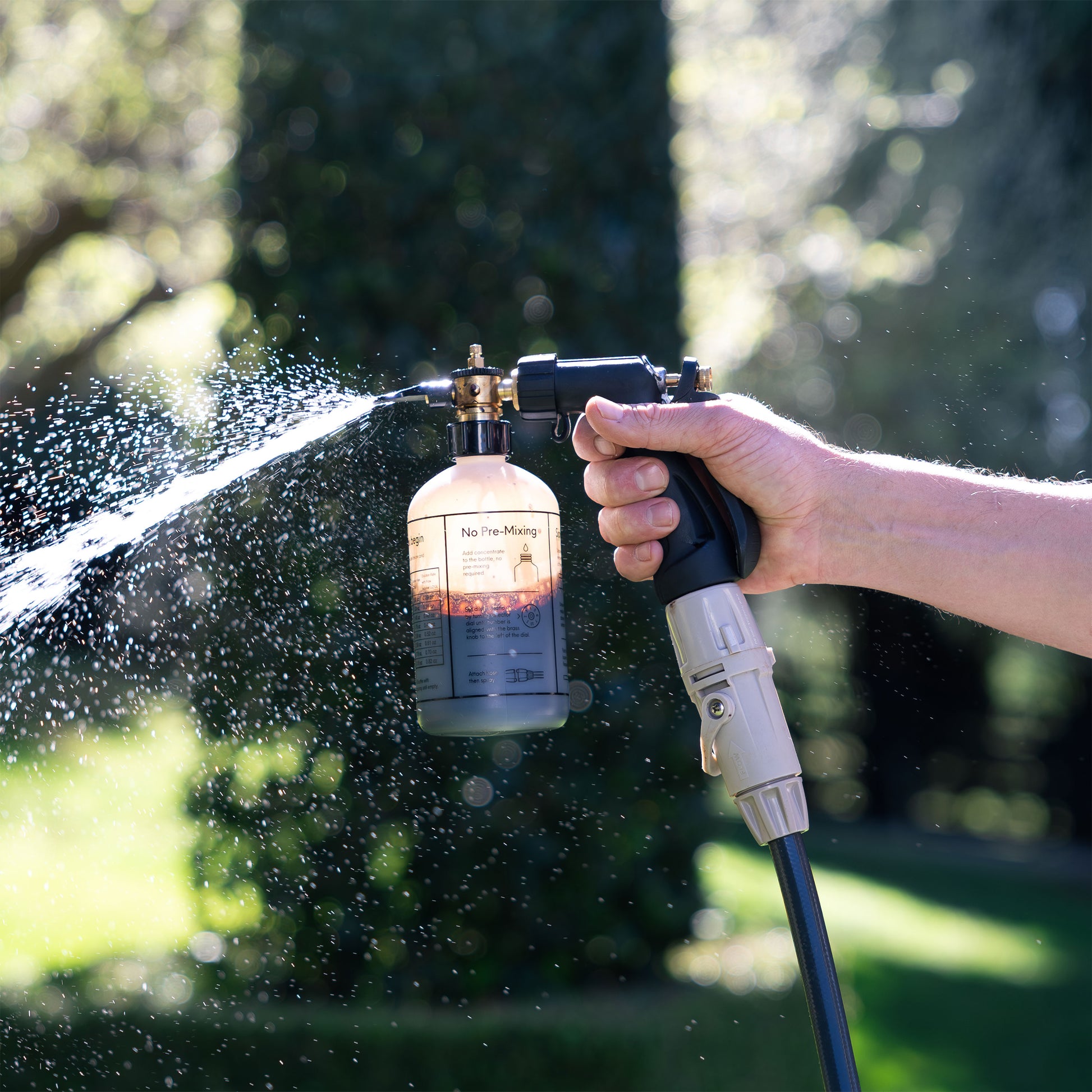 Close up of Ben Hayman using fertiliser spray mixer in backyard