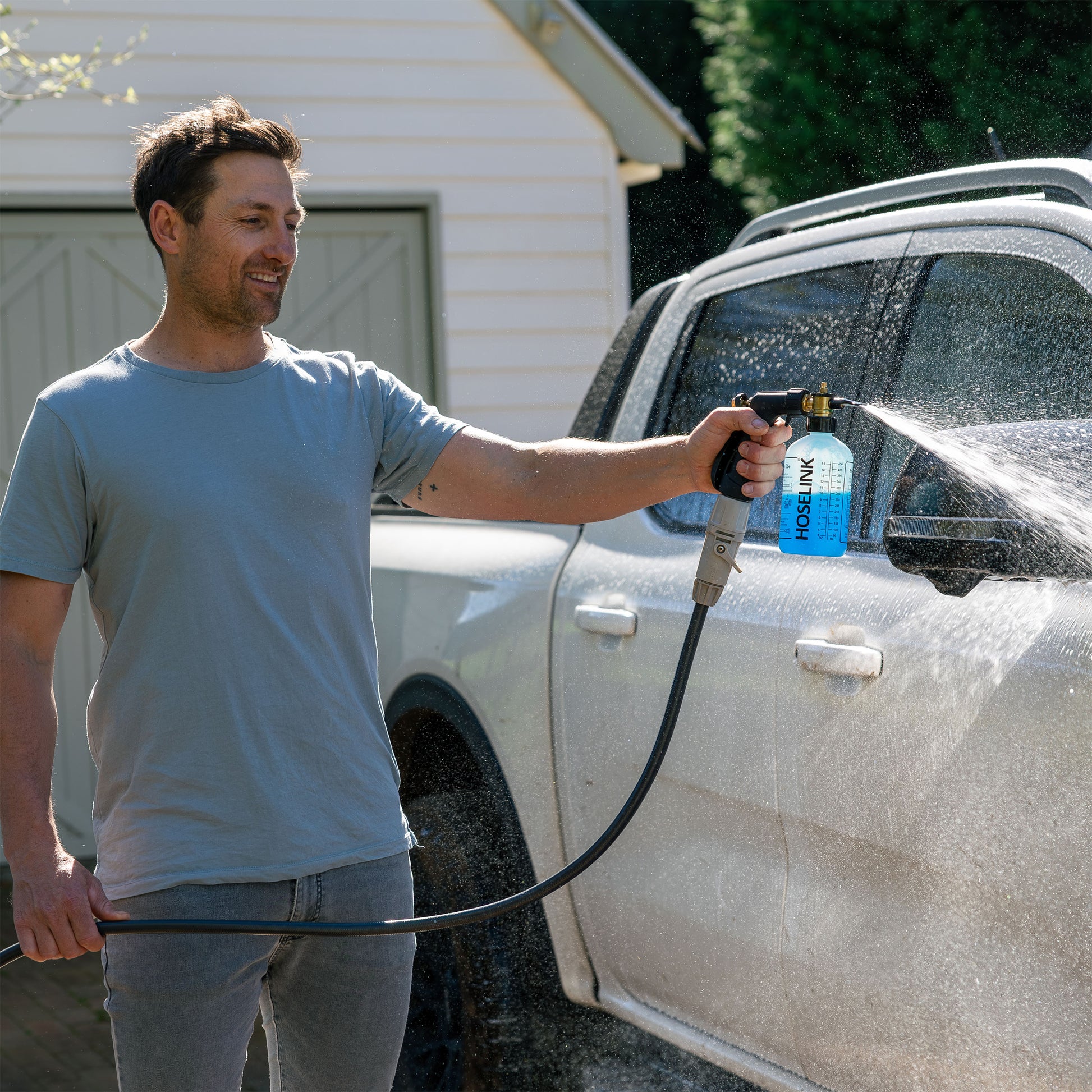 Ben Hayman using fertiliser spray mixer with soap on car