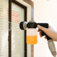 soap spray mixer with orange liquid soap being used to spray a window