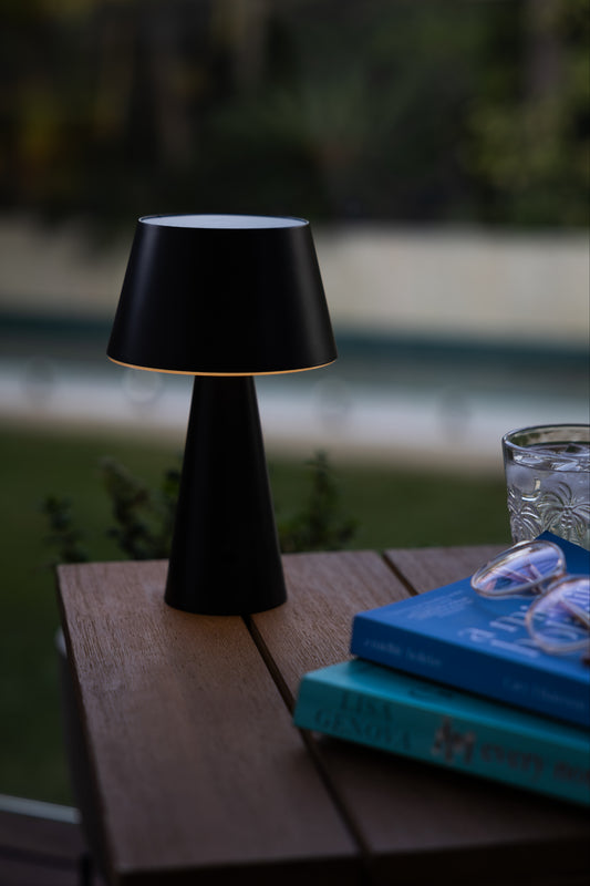 solar out and indoor table lantern on a reading table