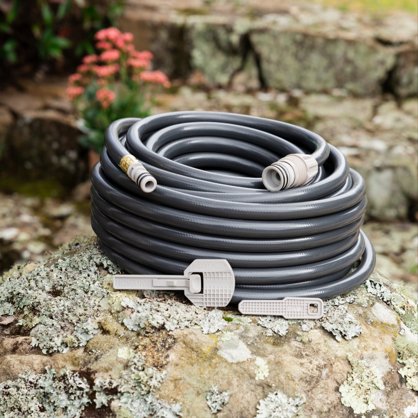 charcoal replacement 20m hose and two safety keys resting on a speckled moss covered rock