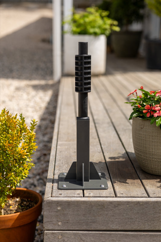 evolve ground mount installed on the corner of a timber deck, next to a gravel driveway with plants on wither side